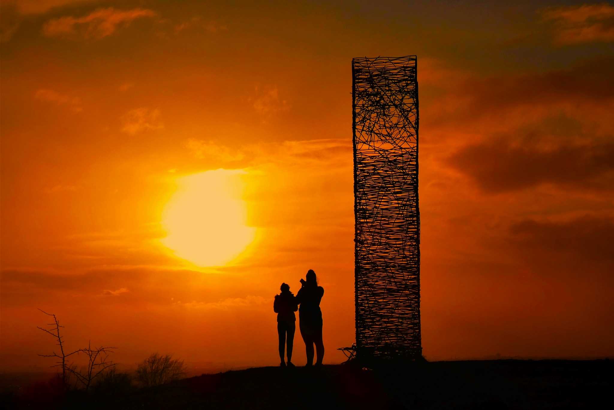 National Walking Month photo entry from Brian Cairns showing two individuals silhouetted against a sunset. 